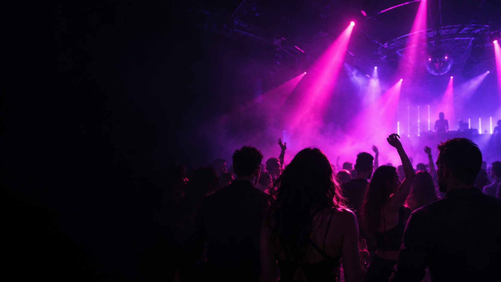 Purple stage lights over a nightclub dance floor